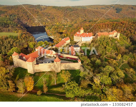 Beautiful autumn landscape with a castle from above from a drone. Beautiful Gothic castle Veveri. The city of Brno at the Brno dam. South Moravia Czech Republic Central Europe. Beautiful autumn landscape with a castle from above from a drone. Beautiful Gothic castle Veveri. The city of Brno at the Brno dam. South Moravia Czech Republic Central Europe. 133082457