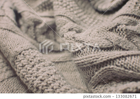 Knit fabric texture, warm winter clothing, sweater, cardigan, Aran pattern Knit fabric texture, warm winter clothing, sweater, cardigan, Aran pattern 133082671