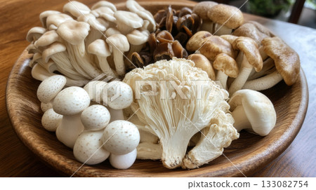 Assorted Fresh Mushrooms in a Woven Basket on Wooden Table 133082754