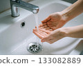 woman washing hands in sink 133082889