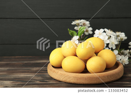 Easter eggs and spring flowers on black background. Easter eggs and spring flowers on black background. 133083452