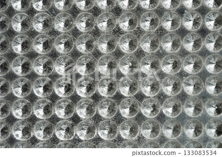 Circular patterns on textured surface reflect light abstractly 133083534