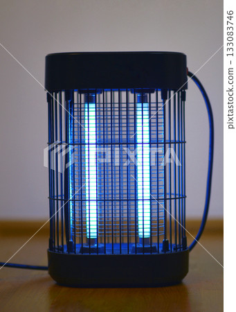 Electric insect killer lamp glowing in blue light Electric insect killer lamp glowing in blue light 133083746