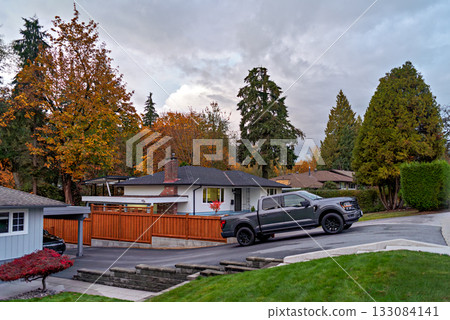 Autumn in residential area with a truck parked on uphil driveway Autumn in residential area with a truck parked on uphil driveway 133084141