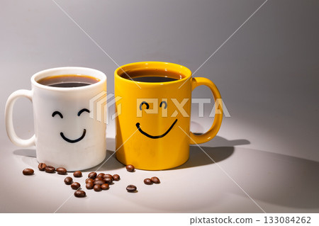 Two Mugs of Coffee With Happy Faces, a Cheerful Morning Beverage Concept Two Mugs of Coffee With Happy Faces, a Cheerful Morning Beverage Concept 133084262