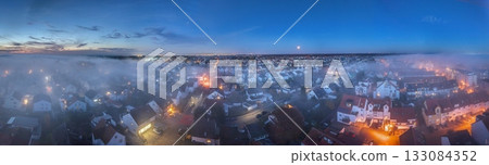 Evening aerial panorama of Moerfelden Walldorf with fog and Frankfurt skyline 133084352