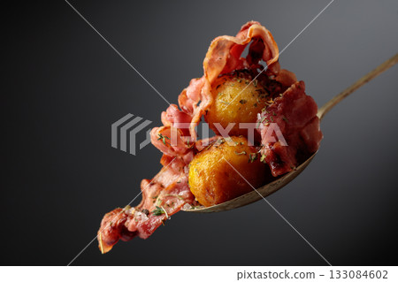 Roasted potatoes with bacon sprinkled with spices. Roasted potatoes with bacon sprinkled with spices. 133084602