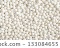 Organic tapioca pearls background. Texture of white dry tapioca pearls, cooking ingredient, gluten-free food, healthy eating. 133084655