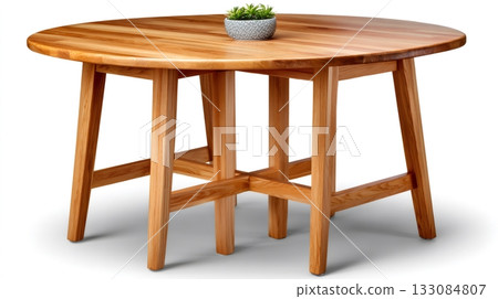 Round wooden oak dining table with small plant 133084807