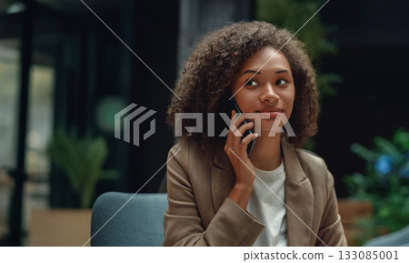 confident businesswoman speaking, professional woman on call, woman in blazer speaking confidently on phone confident businesswoman speaking, professional woman on call, woman in blazer speaking confidently on phone 133085001