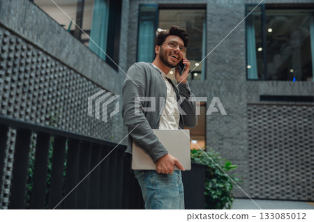 young professional multitasks confidently, individual handles call and schedule efficiently 133085012