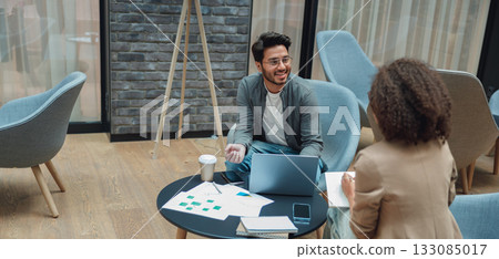 entrepreneurs studying data over coffee, business founders examining reports during discussion 133085017