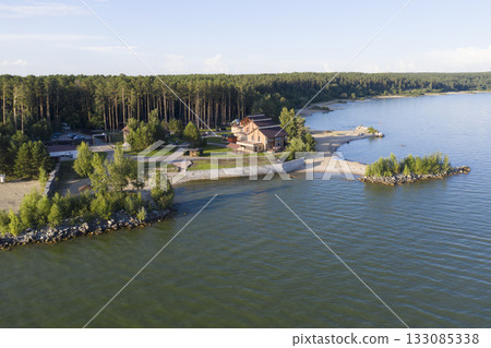 Aerial view of cottage village near the beach on the shore of the Ob Sea in Siberia in summer 133085338