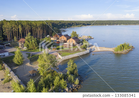 Aerial view of cottage village near the beach on the shore of the Ob Sea in Siberia in summer 133085341