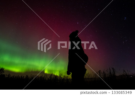The silhouette of a man watching the northern lights The silhouette of a man watching the northern lights 133085349