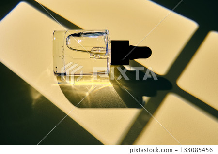Skincare serum dropper bottle with natural light and shadow 133085456