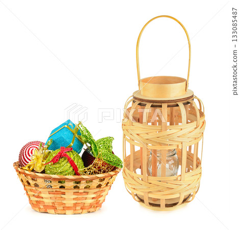 Woven Basket and Lantern with Christmas Ornaments on White. Woven Basket and Lantern with Christmas Ornaments on White. 133085487