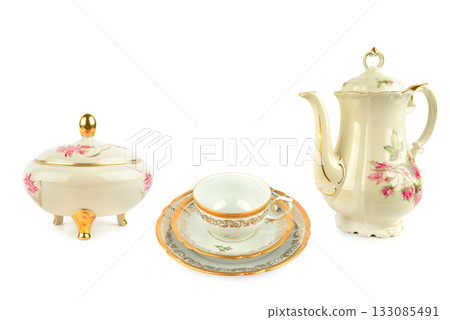 Vintage Porcelain Tea Set Elements with Gold Trim on White. 133085491