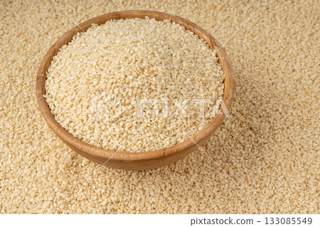 Sesame seeds pile closeup, white small benne grains. Sesamum indicum fruits Sesame seeds pile closeup, white small benne grains. Sesamum indicum fruits 133085549