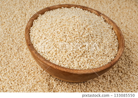 Sesame seeds pile closeup, white small benne grains. Sesamum indicum fruits Sesame seeds pile closeup, white small benne grains. Sesamum indicum fruits 133085550