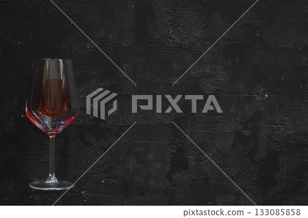 glass of red wine on black background. flat lay. glass of red wine on black background. flat lay. 133085858