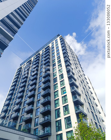 Low angle of contemporary apartment building, urban living architecture in city skyline Low angle of contemporary apartment building, urban living architecture in city skyline 133086052