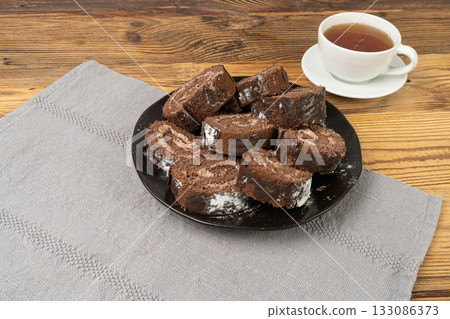 Chocolate Swiss Roll, Round Sponge Cake, Sliced Rolled Vanilla Biscuit with Cocoa Cream Filling Chocolate Swiss Roll, Round Sponge Cake, Sliced Rolled Vanilla Biscuit with Cocoa Cream Filling 133086373