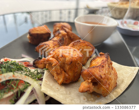 Poultry Shish Kebab, Barbecue Shashlik with Thin Pita Bread and Fresh Vegetables 133086377