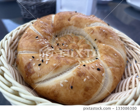 Uzbek round bread. Traditional breakfast tandir bakery, Kazakh tandoor lavash Uzbek round bread. Traditional breakfast tandir bakery, Kazakh tandoor lavash 133086380