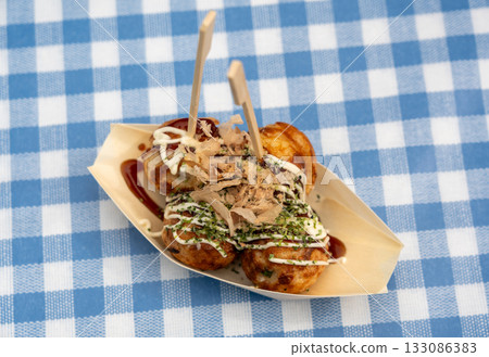 Takoyaki - traditional Japanese street food, outdoor snack with octopus Takoyaki fried balls 133086383