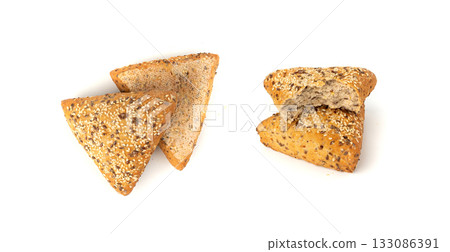 Triangular bun isolated. Wheat bread with sesame and flax seeds, healthy whole grain bakery Triangular bun isolated. Wheat bread with sesame and flax seeds, healthy whole grain bakery 133086391