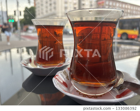 Turkish Tea on a Street Cafe Table, Traditional Arabic Cup in Restaurant, Black Tea Drinking Turkish Tea on a Street Cafe Table, Traditional Arabic Cup in Restaurant, Black Tea Drinking 133086392