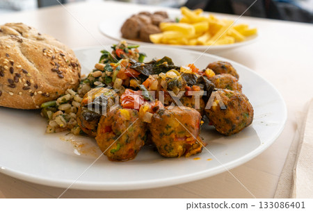 Vegan meatball, round cutlet dinner on white plate. Fried vegetable balls, falafel 133086401