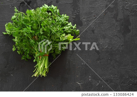 Fresh parsley bunch on black background, top view 133086424