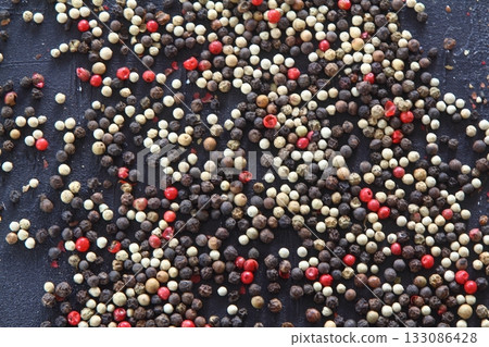 A mixture of peppers. Black, white, red polka dots. Isolated on a white background. 133086428