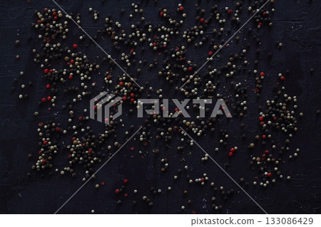 A mixture of peppers. Black, white, red polka dots. Isolated on a white background. 133086429