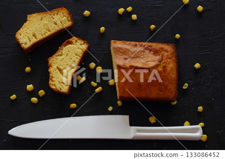 corn bread with knife on black background. with fresh corn. 133086452