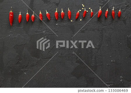 red hot chili peppers on black background red hot chili peppers on black background 133086469