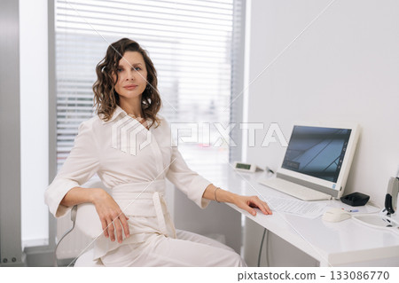 Portrait of confident female doctor, medical professional sitting in modern clinic office, looking at camera, embodying expertise and reliability in healthcare technology. Concept of beauty treatment. Portrait of confident female doctor, medical professional sitting in modern clinic office, looking at camera, embodying expertise and reliability in healthcare technology. Concept of beauty treatment. 133086770