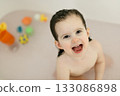 Bath time with laughing toddler in family bathroom 133086898