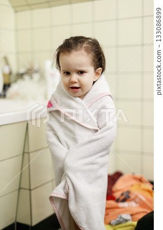 Little girl after bath wrapped in white towel Little girl after bath wrapped in white towel 133086899