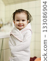 Smiling toddler girl wrapped in towel after bath 133086904