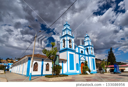 Immaculate Conception Church in Concepcion, Junin, Peru. The white and blue colonial-style building stands under a dramatic cloudy sky Immaculate Conception Church in Concepcion, Junin, Peru. The white and blue colonial-style building stands under a dramatic cloudy sky 133086956
