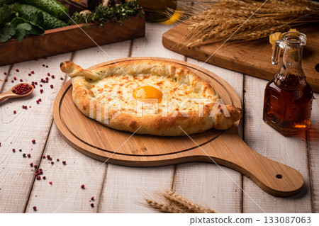 Khachapuri with egg on wooden board Khachapuri with egg on wooden board 133087063