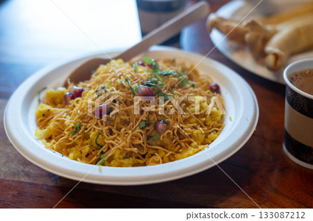 Poha Indian breakfast food close up. Healthy pohe rice flakes dish 133087212