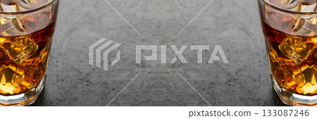 Iced Whiskey Glass on Natural Black Stone Background 133087246