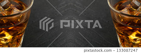 Iced Whiskey Glass on Natural Black Stone Background Iced Whiskey Glass on Natural Black Stone Background 133087247