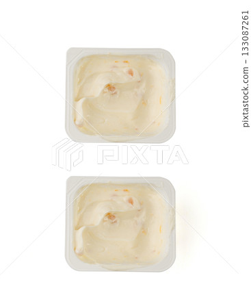 Yogurt cup isolated, yoghurt with orange fruits pieces in plastic pot, milk pudding container Yogurt cup isolated, yoghurt with orange fruits pieces in plastic pot, milk pudding container 133087261