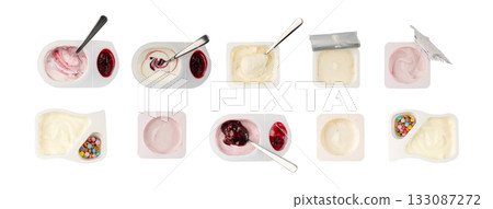 Yogurt cup isolated, yoghurt with orange fruits pieces in plastic pot, spoon in milk pudding 133087272