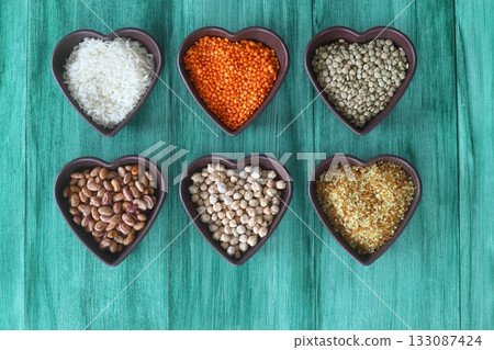 Different type of raw dry legumes composition. White Rice, lentils, red lentils, chickpeas and kidney beans. Different type of raw dry legumes composition. White Rice, lentils, red lentils, chickpeas and kidney beans. 133087424